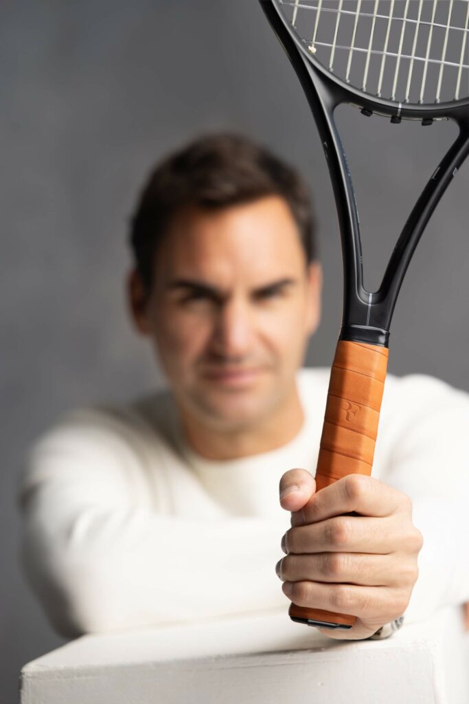 Roger Federer holding RF racket.